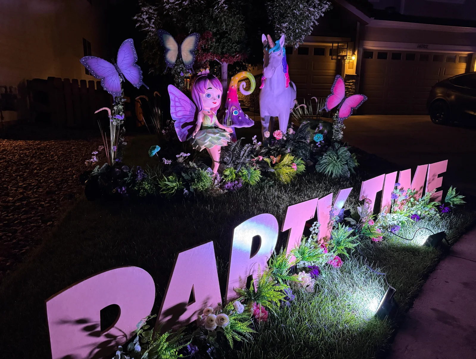 Enchanted Garden Legend package after dark — illuminated yard letters
